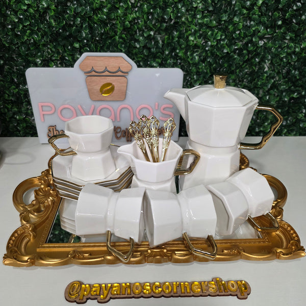 Luxury white and gold ceramic coffee set featuring a matching coffee pot, cups, saucers, gold spoons and decorative mirrored serving tray.
